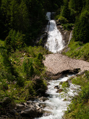 Wall Mural - Waterfall partly covered with remains of snow