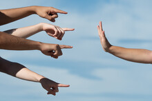 Hands Pointing To A Person Making The Stop Gesture With The Palm. Accusation And Guilt Concept.