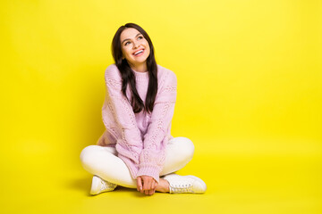 Wall Mural - Full body photo of lovely young lady sit look empty space wear sweater pants isolated on yellow color background