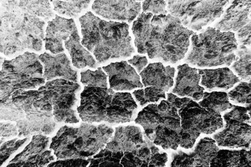 abstract black background with white cracks overlay ground cracked drought, old paint