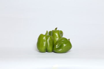 Canvas Print - Closeup of three fresh green bell peppers isolated on a white background