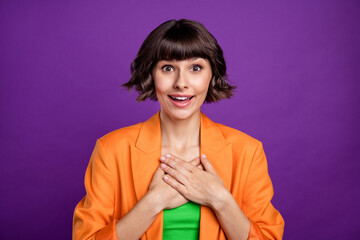 Sticker - Photo of sincere young brunette lady hands heart wear orange blazer top isolated on violet color background