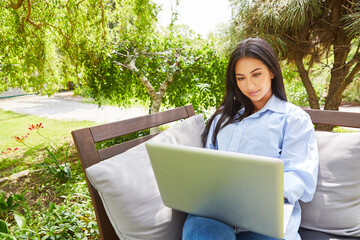 Business woman working on laptop computer in the garden