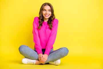 Sticker - Full size photo of young happy smiling positive girl look copyspace sit floor with folded legs isolated on yellow color background