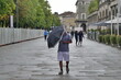 Man walking in the city with umbrella, after rain heavy rain