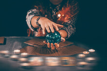 Tarot Reader With Tarot Cards.Tarot Cards Face Down On Table Near Burning Candles And Crystal Ball.