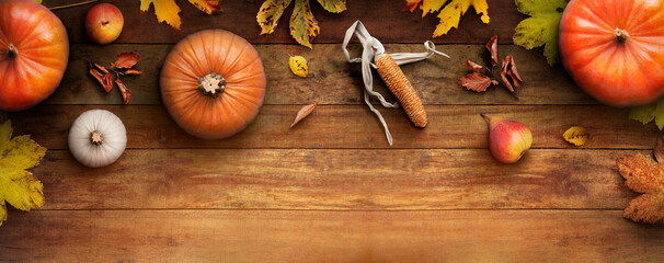 Sticker - a thanksgiving autumn harvest background of pumpkins, pears, leaves and corncobs on a rustic wooden 