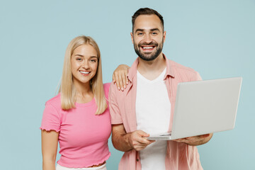 Sticker - Young happy couple two friends family man woman in casual clothes hold use work on laptop pc computer together isolated on pastel plain light blue background studio portrait People lifestyle concept.