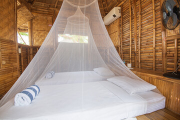 Hotel room in a rustic style with two canop beds