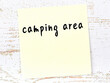 Yellow sheet of paper with word camping area. Reminder concept