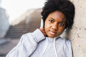 Wall Mural - Portrait of a thoughtful black mixed race african female on concreate place