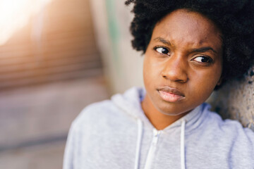 Wall Mural - Portrait of a thoughtful black mixed race african female on concreate place