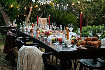 Banquet table setting and arrangement. Holiday table beautifully set with floral decoration. Close up, copy space, background.