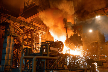 Pouring molten metal into a metallurgical electric arc furnace