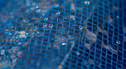 background  water droplets on the blue net