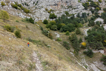 Sticker - a man walking a mountain trail