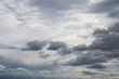 Replacement sky background or backdrop with darker white cumulus clouds below and altostratus clouds above in a dramatic blue sky.