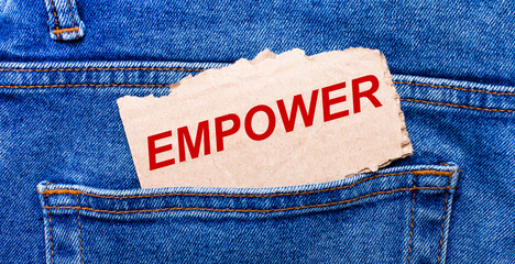 In the back pocket of the jeans there is a brown piece of paper with the text EMPOWER