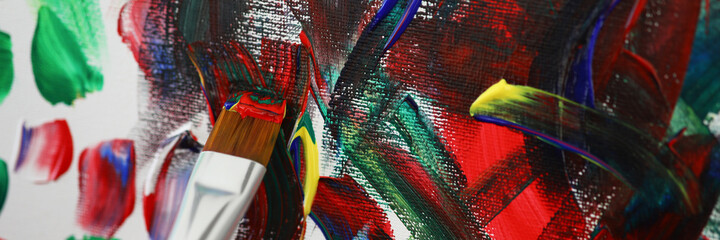 Artist painting picture with multicolored oil paints closeup