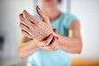 © astrosystem - Woman with hand and arm pain at home.