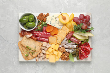 Wall Mural - Different tasty appetizers on light marble table, top view