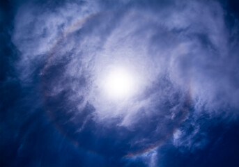 The colors of the solar halo hidden by the clouds, view from Sicily, Italy.