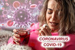 © Lucky Fenix - woman sick in bed with temperature drinks hot tea-Covid.