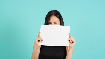 Wall Mural - Blank empty paper in asian woman's hand on mint green or Tiffany Blue background.