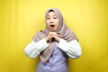 Beautiful young asian muslim woman shocked, surprised, wow expression, isolated on yellow background