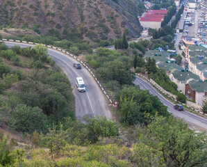 Sticker - Mountain winding road in the mountains near the village.