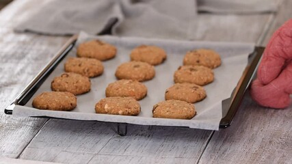 Wall Mural - Oatmeal cookies close-up on a baking sheet on the table.