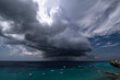 Thundershower scenery with flying clouds over the turquoise sea around Curacao, the Caribbean