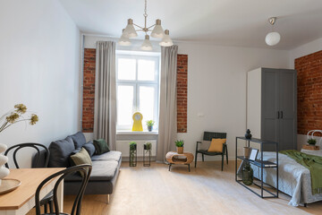 Wall Mural - Living room interior in scandinavian style with stylish furniture and bricks wall. Cozy home with modern room with sofa, table and wooden floor.