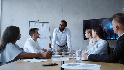Poster - Positive african american businessman talking to young male manager during team building discussion at office, zoom in