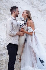 Wall Mural - Beautiful wedding couple bride and groom at wedding day outdoors at ocean beach. Happy marriage couple o