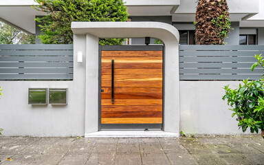 Poster - contemporary house front entrance natural wood door by the sidewalk, Athens Greece