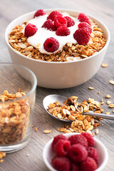 Wall Mural - Sweet breakfast with granola, yogurt and fresh raspberries