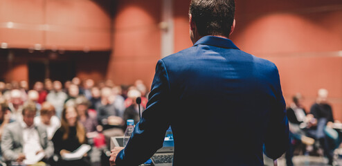 Wall Mural - Public speaker giving talk at Business Event.