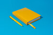 © Ruslan Grumble - Photo of closed yellow notebook and ball-point pen over blue background. Minimalist image of closed diary and yellow pen as back to school concept.