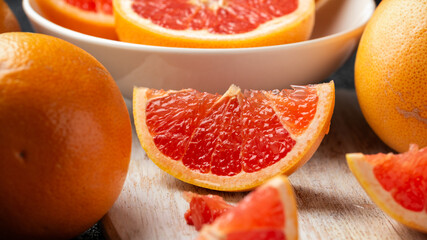 Wall Mural - Juicy Grapefruit slices on white wooden board. Healthy food