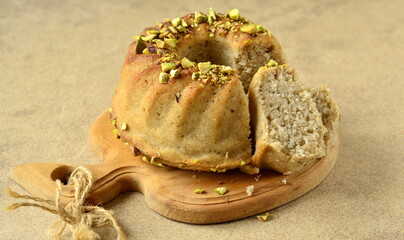 Wall Mural - Homemade semolina cake with coconut and pistachios, copy space