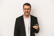 © Asier - Young business man holding a mobile phone isolated on white background screaming very angry and aggressive.