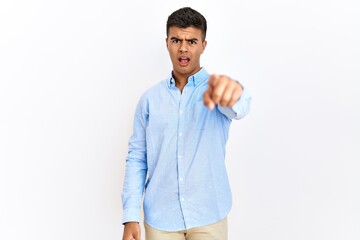 Canvas Print - Young hispanic man wearing business shirt standing over isolated background pointing displeased and frustrated to the camera, angry and furious with you