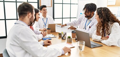 Wall Mural - Group of young doctor people discussing in a medical meeting at the clinic office.