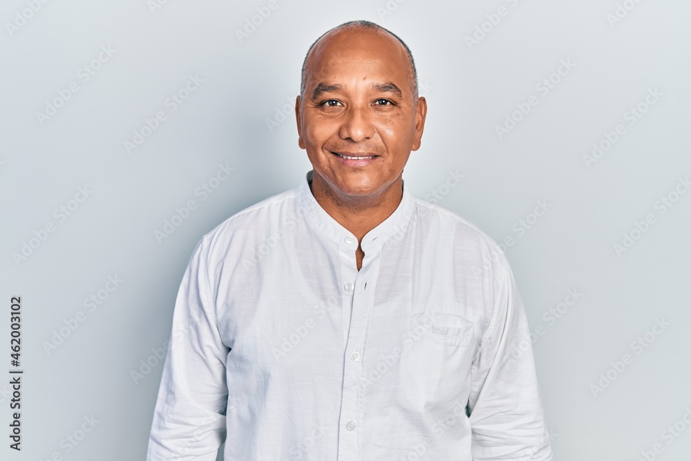 Middle age latin man wearing casual clothes with a happy and cool smile on face. lucky person.