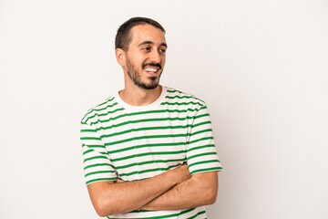 Young caucasian man isolated on white background smiling confident with crossed arms.