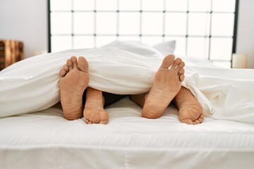 Canvas Print - Couple feet on bed.