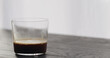 espresso in tumbler glass on black aok table