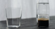 espresso in tumbler glass on black oak table