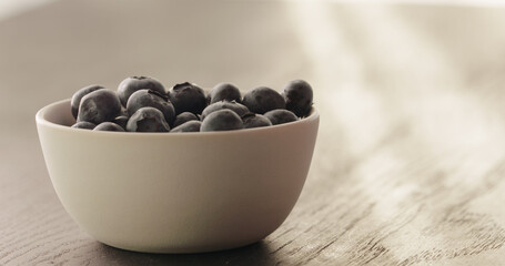 Wall Mural - blueberries in white bowl on oak table